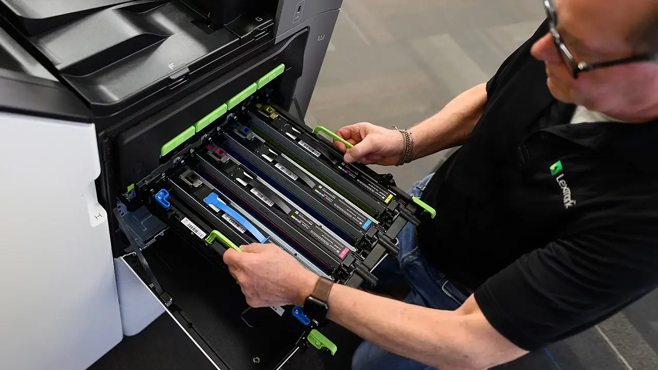 Technician servicing a Lexmark printer with professional maintenance tools – Laserfast Australia