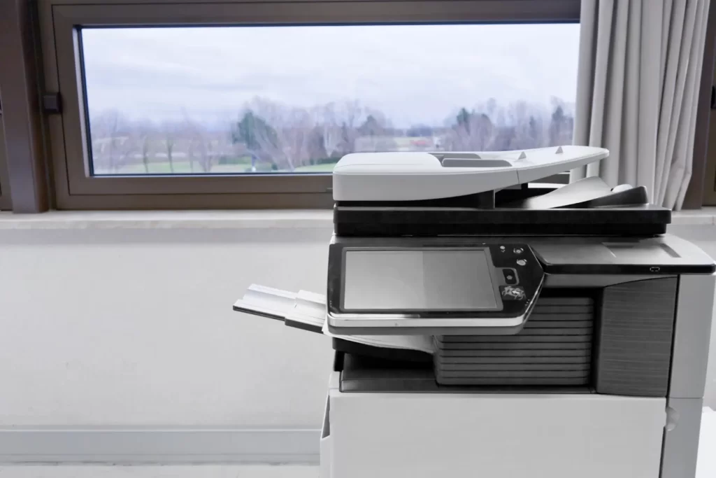 Office printer placed near a sunny window