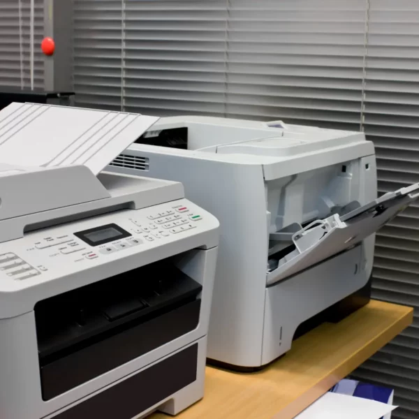 Office printer placed in a tight corner with limited airflow