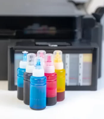 Modern office printer beside toner boxes – guide on toner replacement vs printer upgrade.